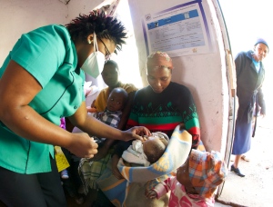 A Basotho nurse preps an infant for immunization in a rural health clinic. (Photo: mjj)
